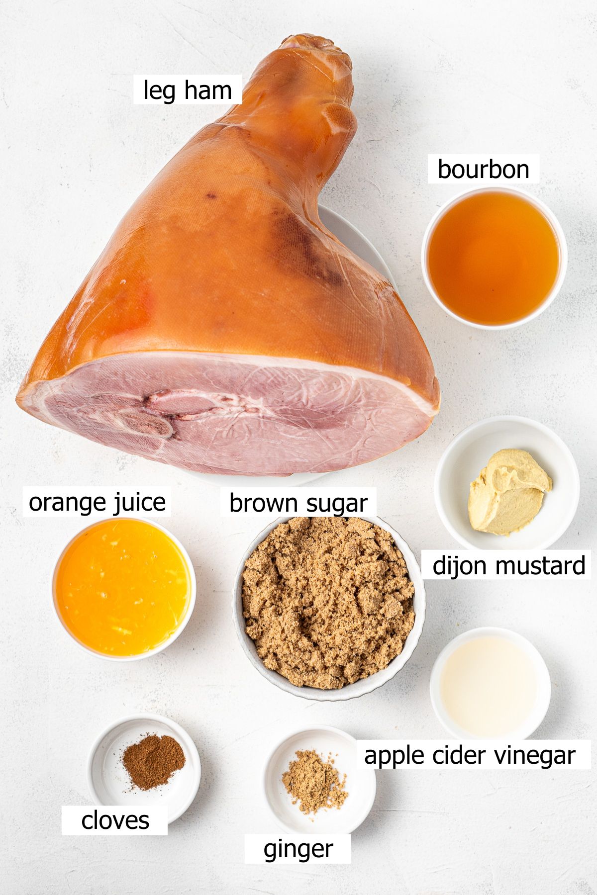 All ingredients needed to make bourbon brown sugar glazed ham laid out in bowls.