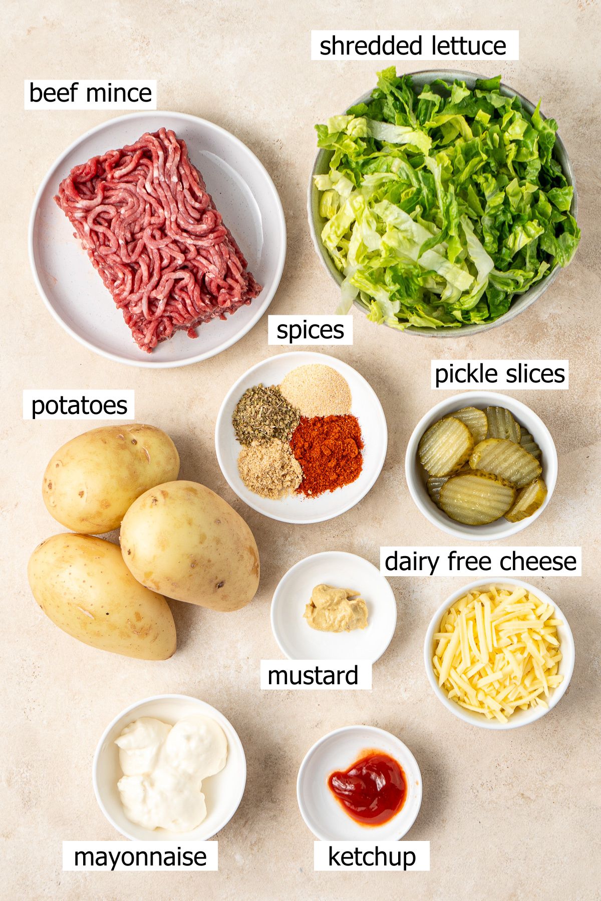 All ingredients needed for burger bowls laid out in bowls.