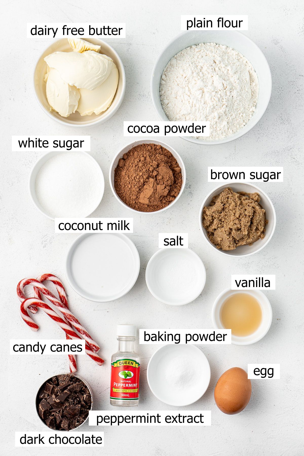 All ingredients needed for chocolate peppermint cookies laid out in bowls.