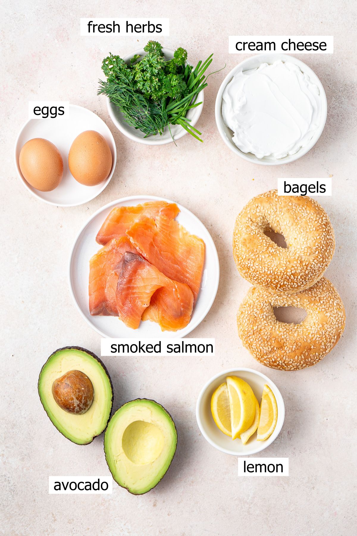 All ingredients needed to make smoked salmon bagels laid out.