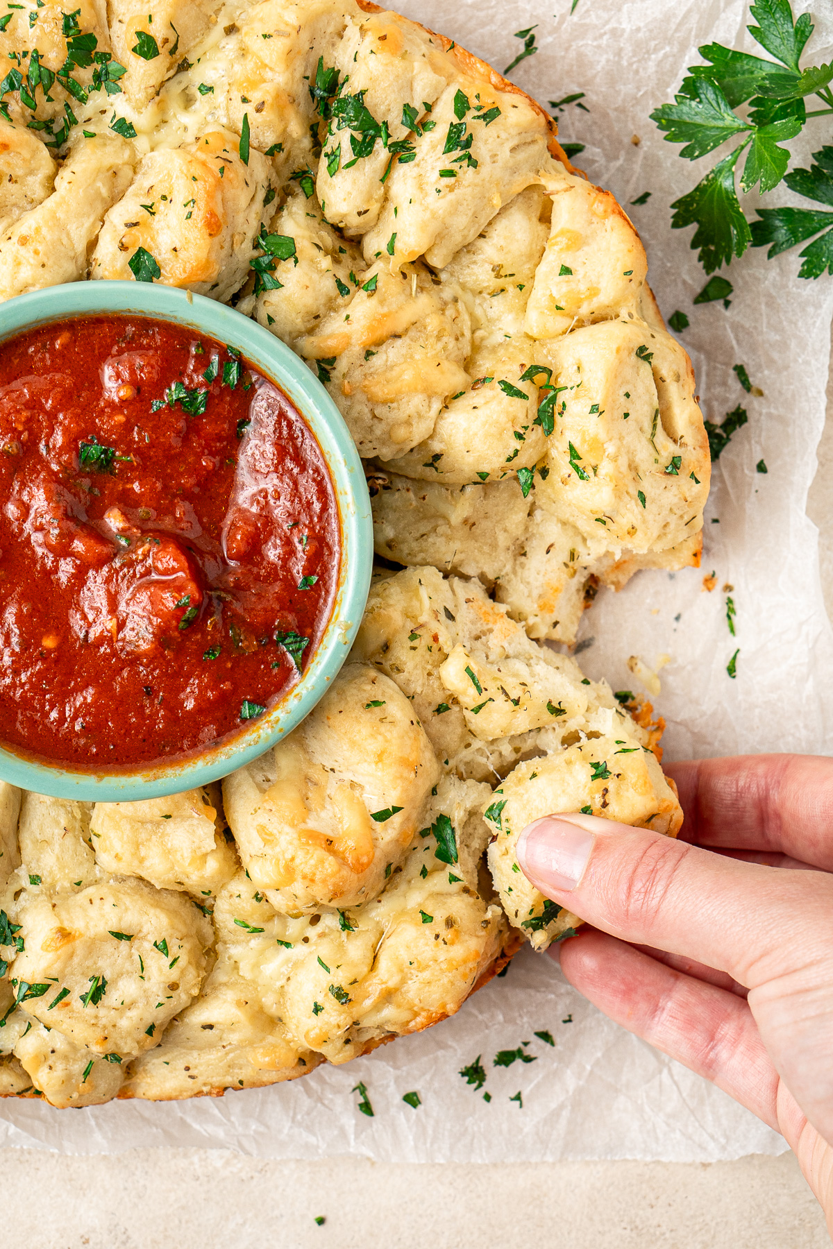 Pulling apart the garlic bread wreath.