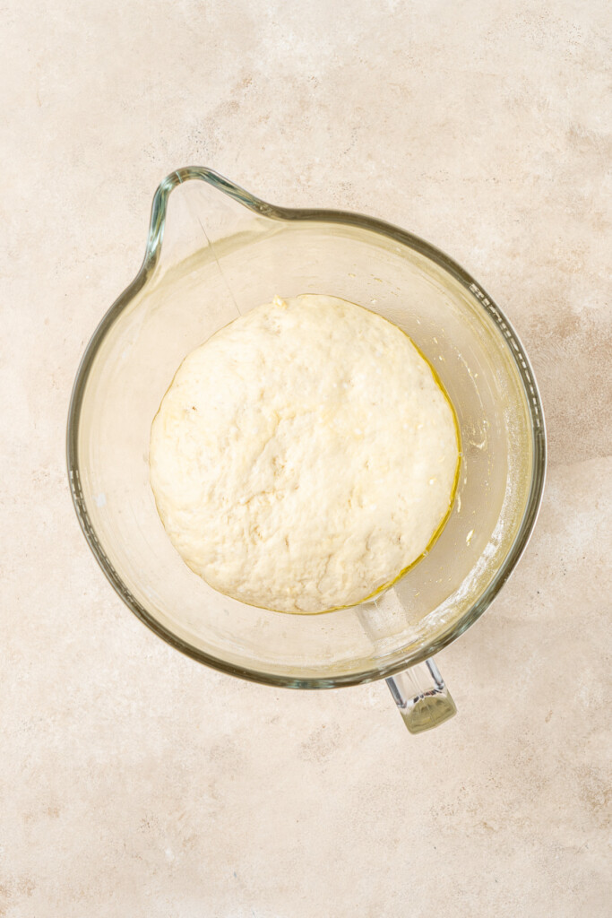 The dough in a bowl after doubling in size.