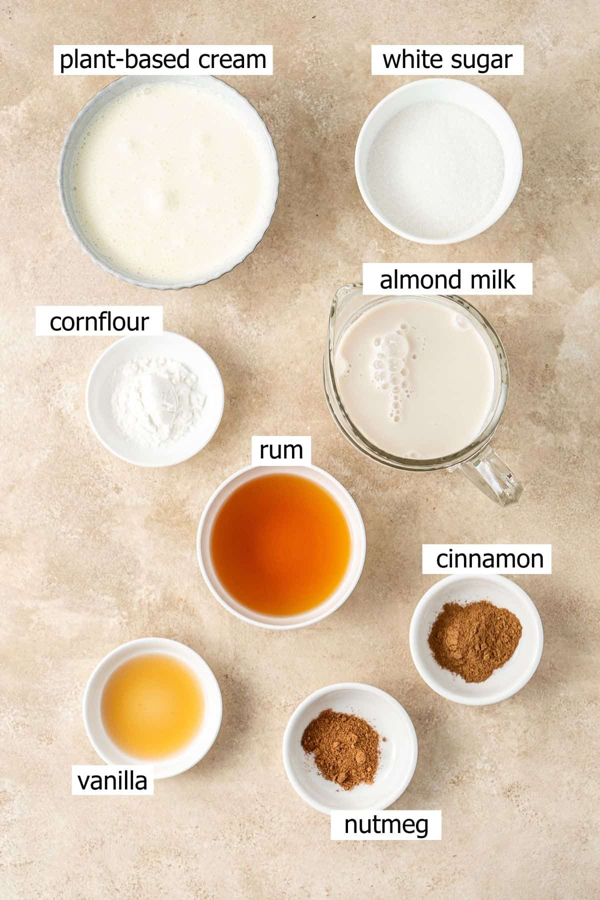 All ingredients needed to make vegan eggnog laid out in bowls.