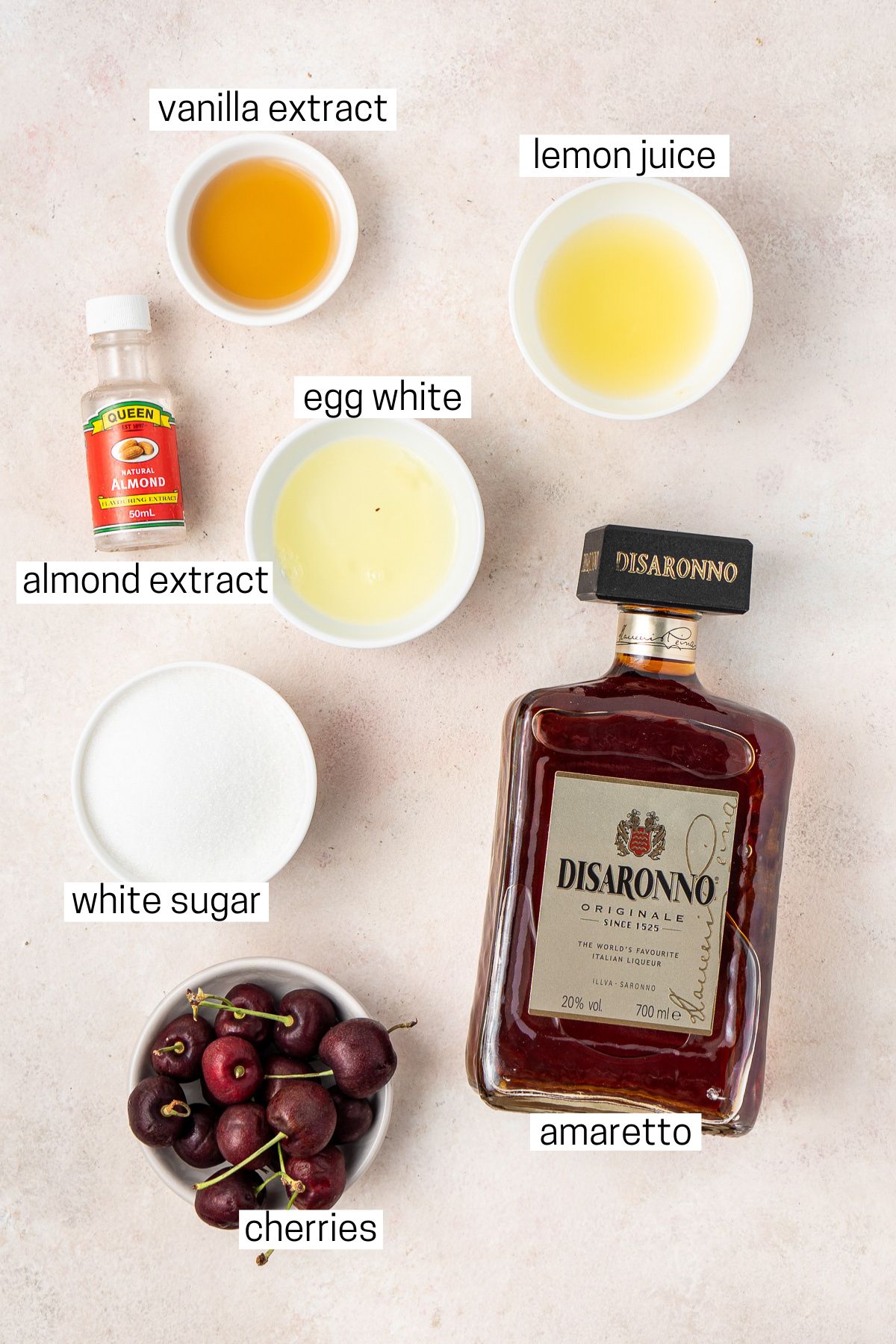 All ingredients needed to make amaretto sour laid out in bowls.