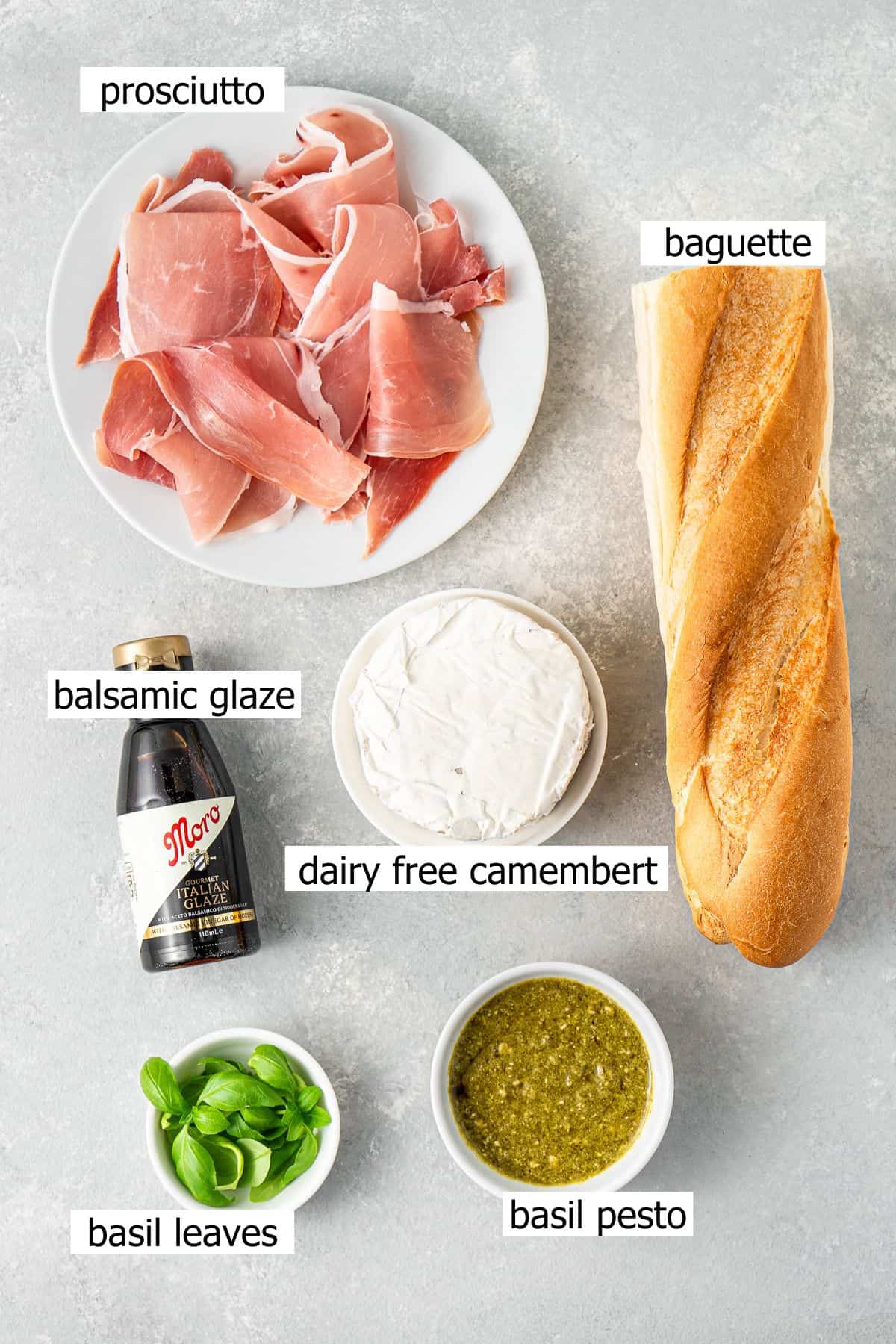 All ingredients needed to make prosciutto crostini laid out in bowls.