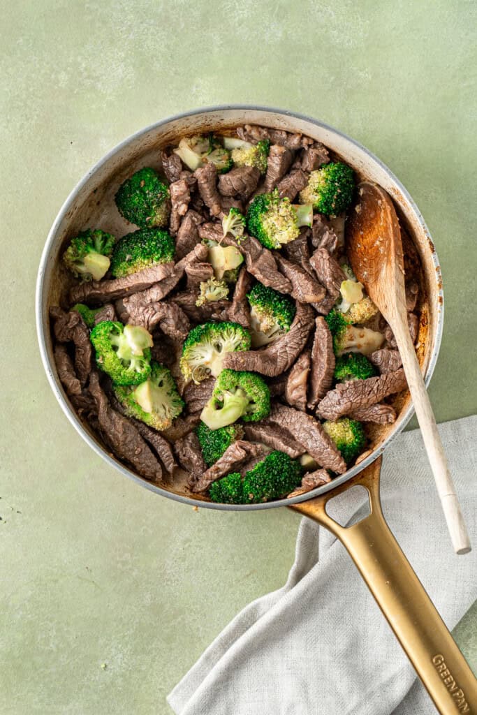 The beef and broccoli back in the pan.