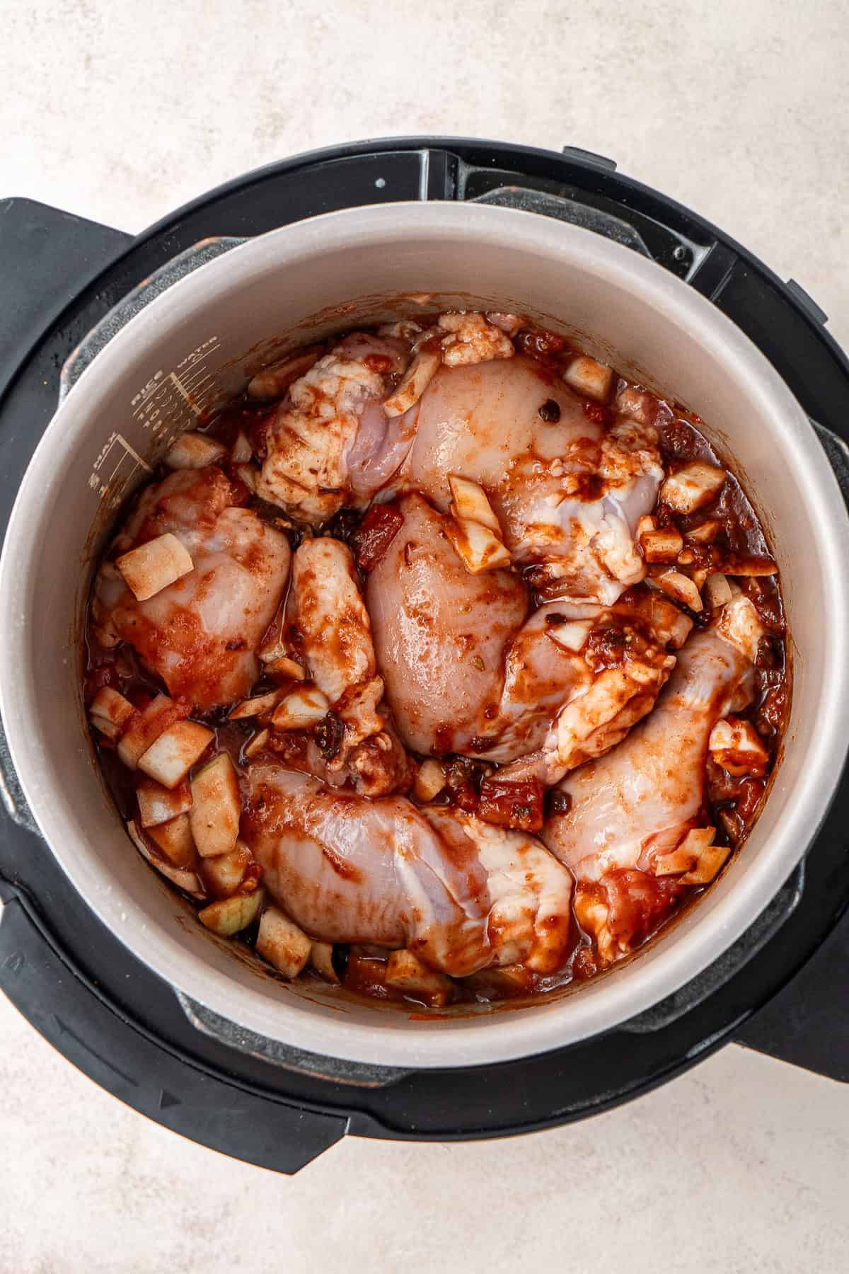 The chicken and remaining ingredients in a slow cooker.