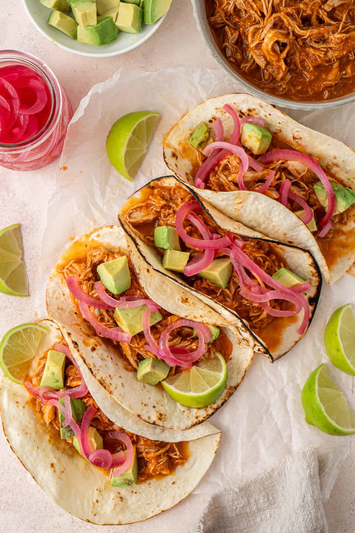 Chicken tinga tacos with pickled red onions.