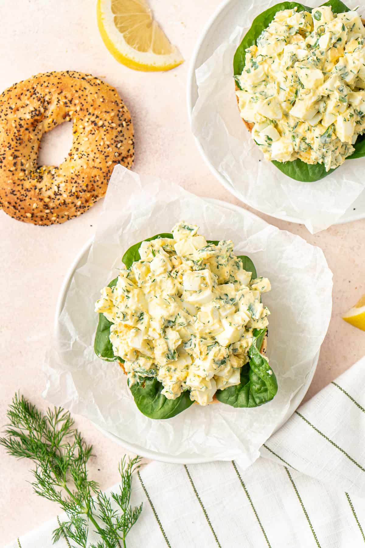 Overhead view of the egg salad piled on top of the bagels. 