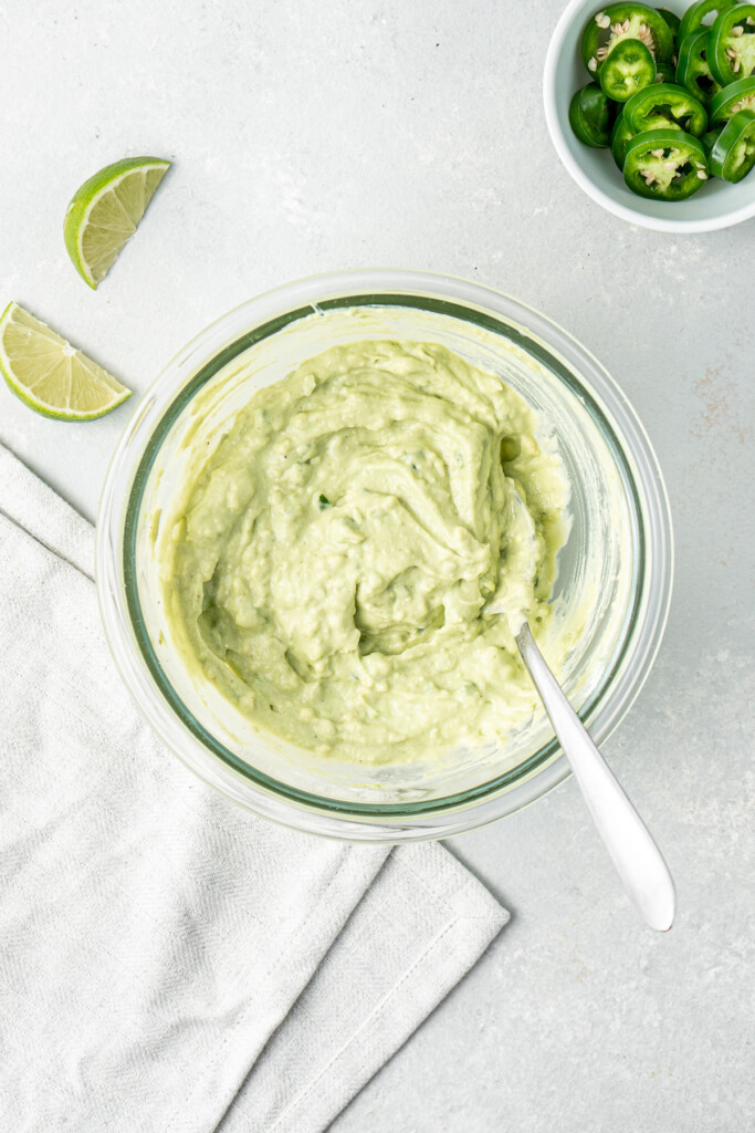 The avocado crema mixed up in a glass bowl.