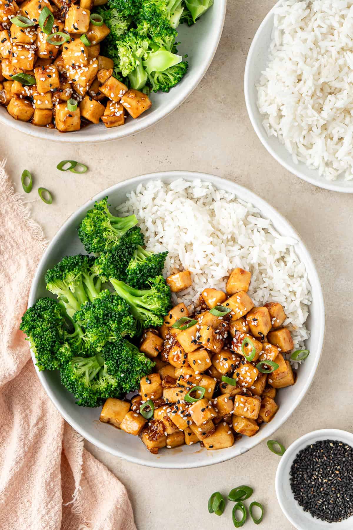 The honey garlic tofu with rice and broccoli served into bowls.