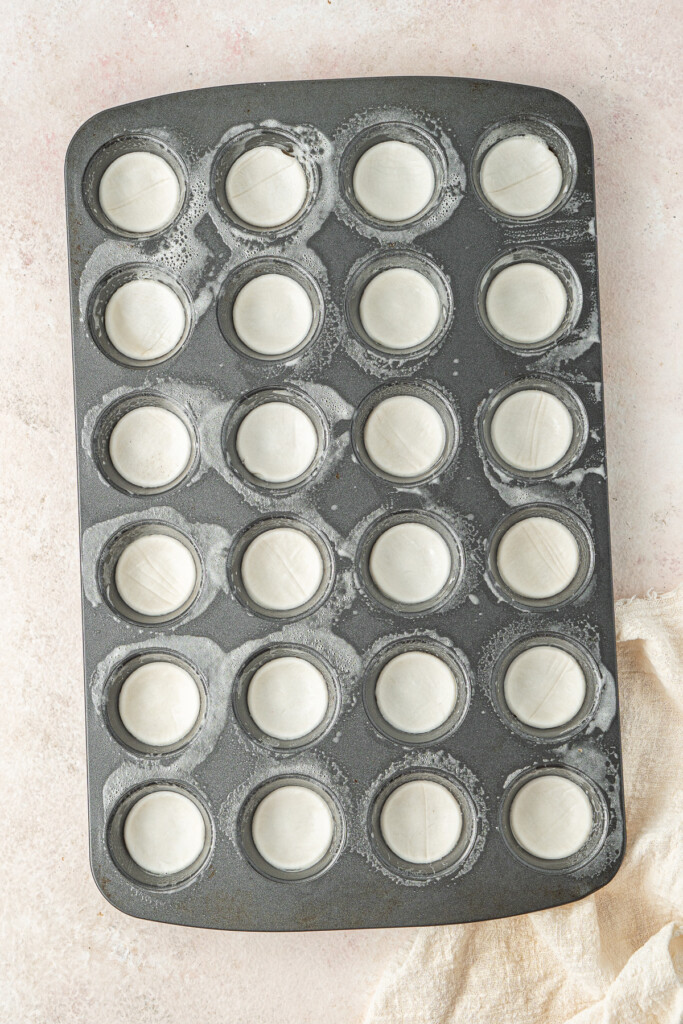 Pastry rounds in a mini muffin pan.