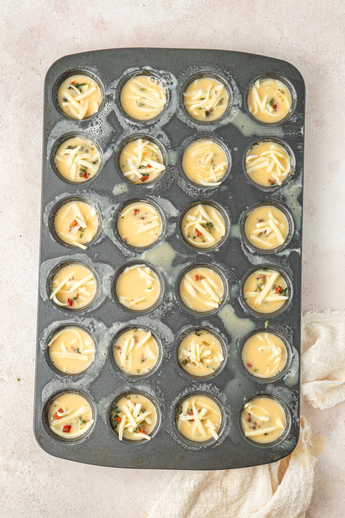 Filling the muffin pan with the egg mxture.