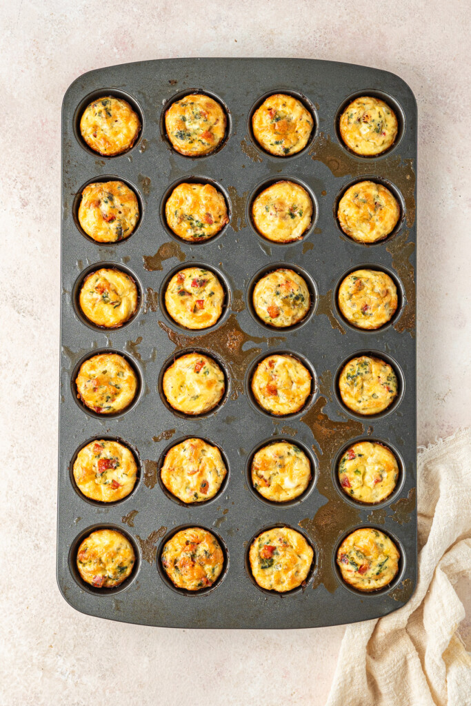 Baked and golden brown mini quiches in a mini muffin pan.