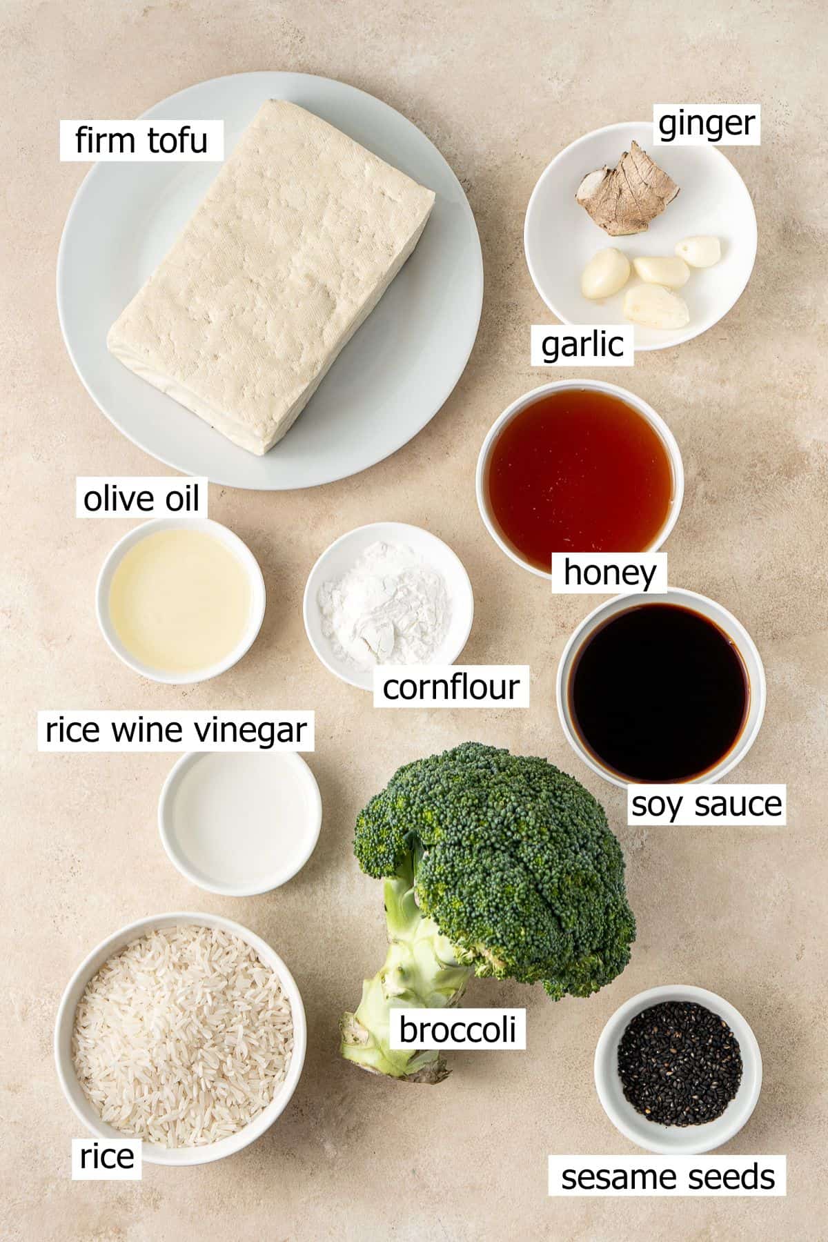 All ingredients needed to make honey garlic tofu laid out in small bowls. 