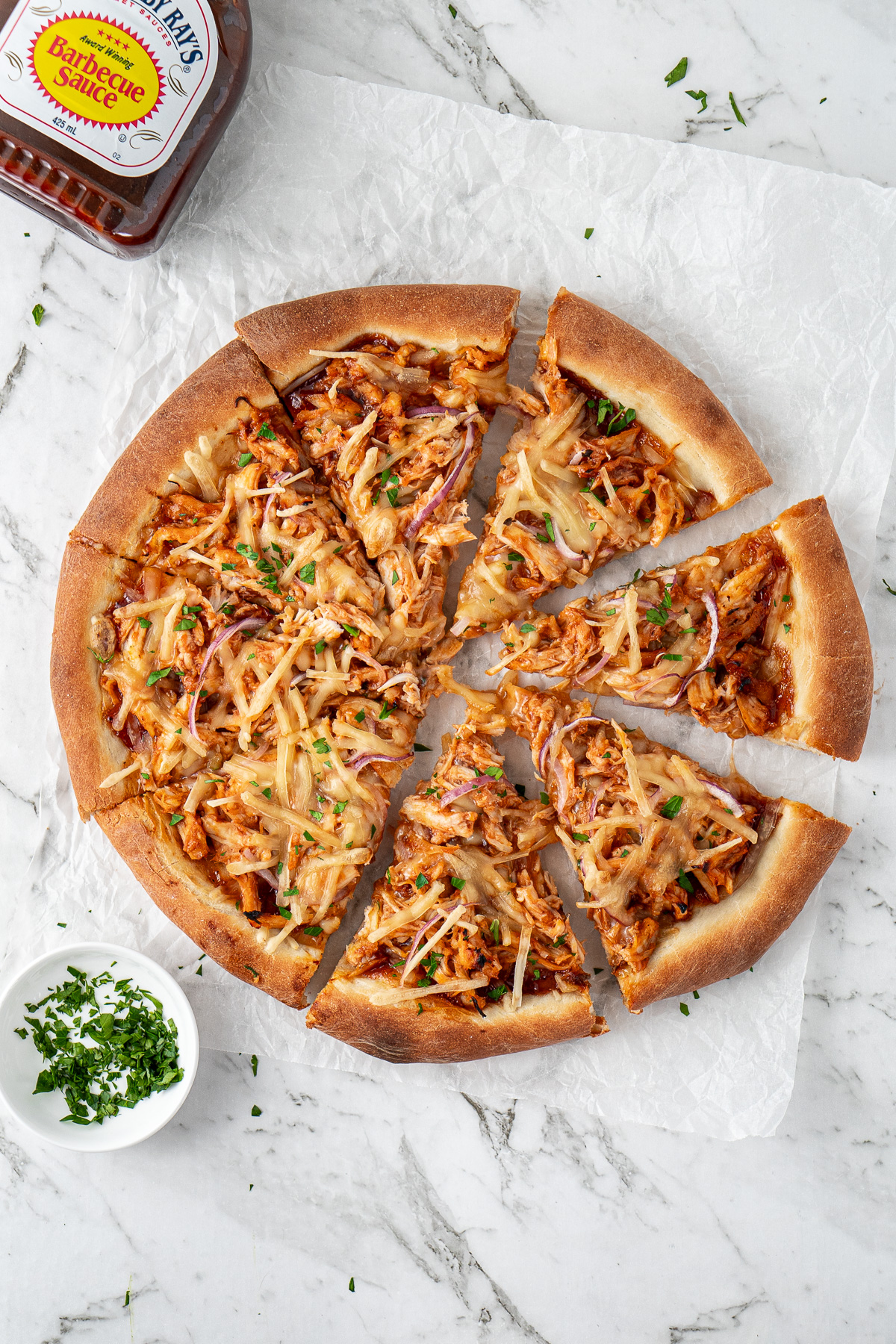 A sliced dairy free BBQ chicken pizza.