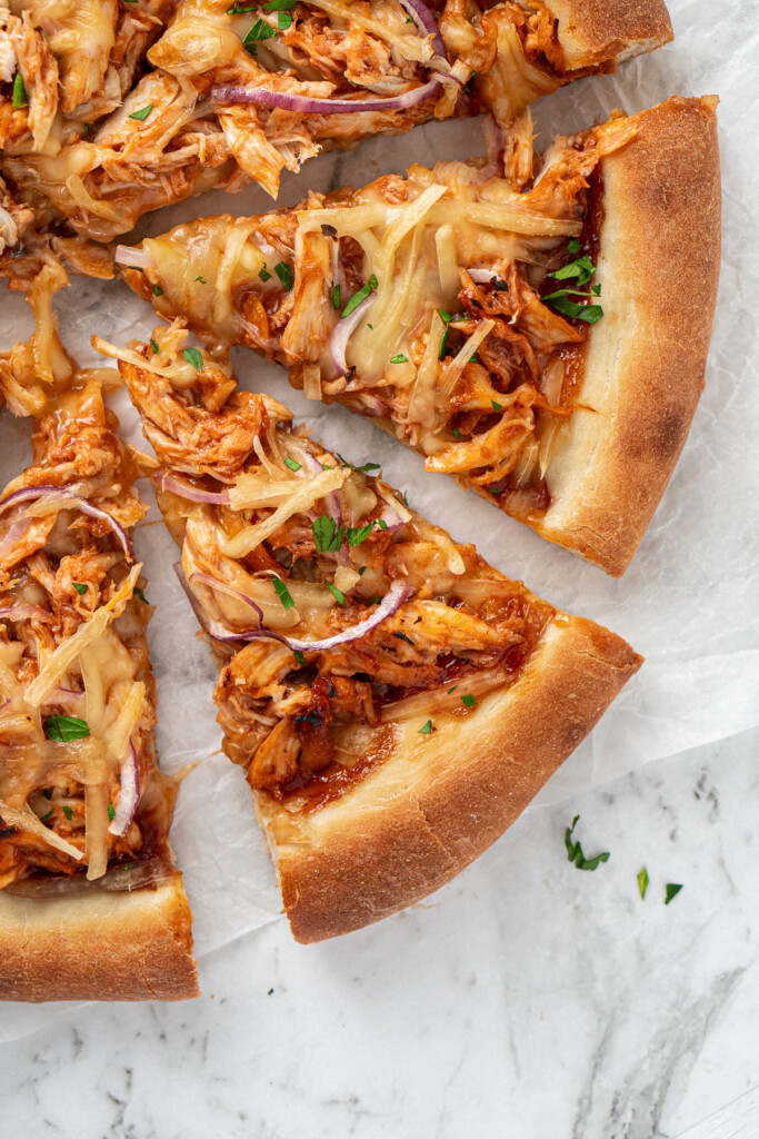 Close up of cut slices of BBQ chicken pizza.