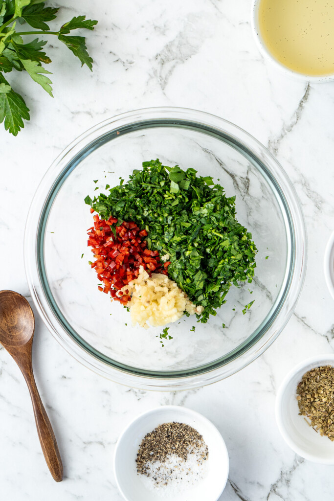 The finely chopped garlic, chilli and parsley in a glass bowl.