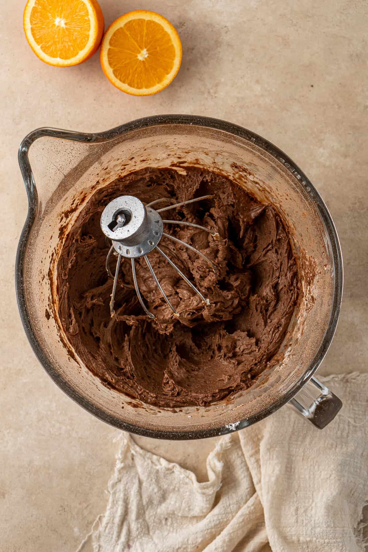 Chocolate orange buttercream in the bowl of a stand mixer.