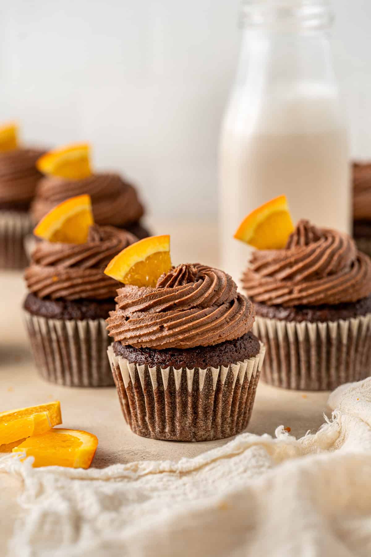 Chocolate orange cupcakes with fresh orange slices.