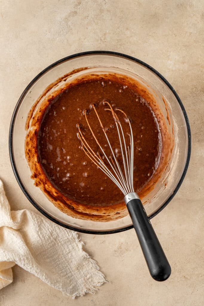 The cupcake batter in a bowl with a whisk.