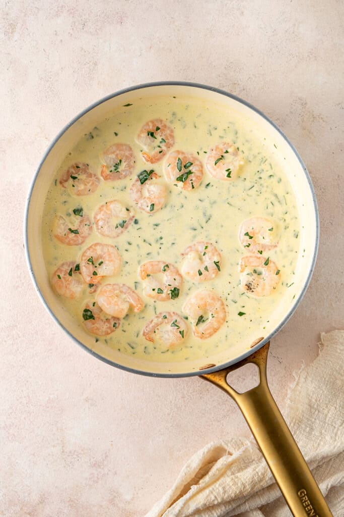 The cooked prawns in the creamy sauce.