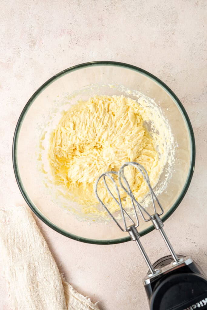 Using electric mixer to beat the wet ingredients in a large mixing bowl.