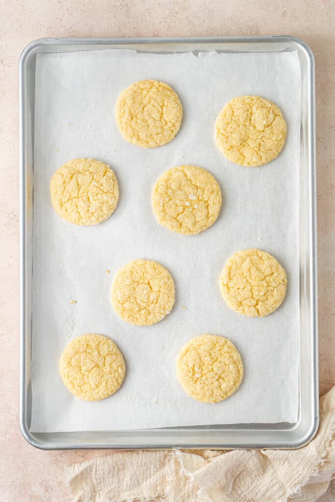 Freshly baked lemon cookies on a baking tray.