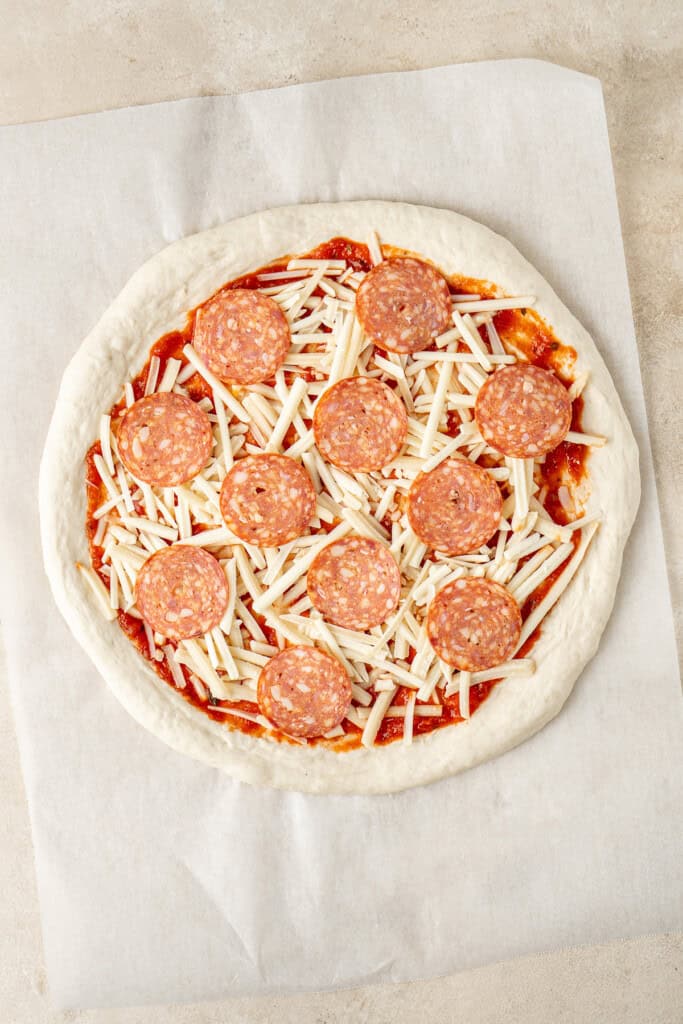 Pepperoni on top of the cheese.