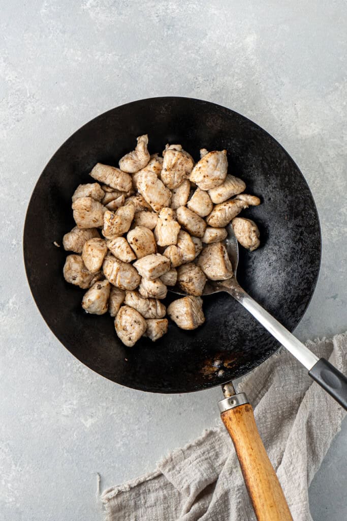 Cooking the chicken in a wok.