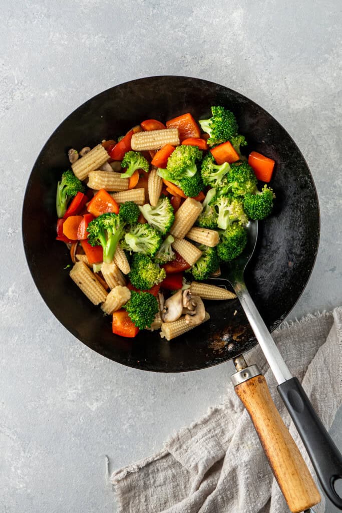 Cooking the vegetables in a wok.