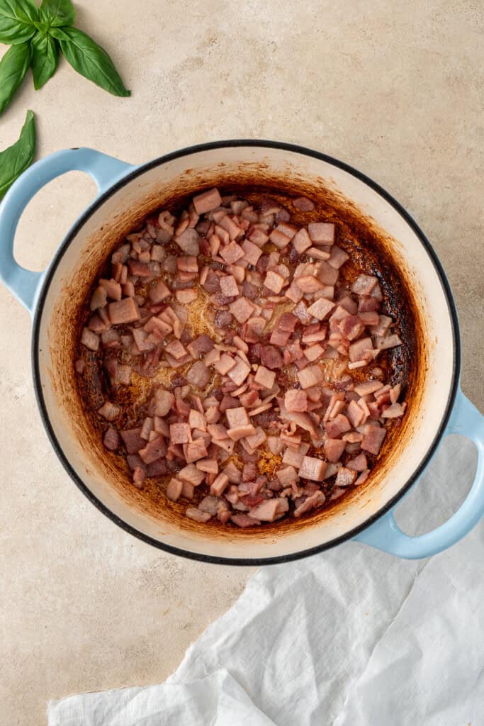 Cooking the bacon in the pot.