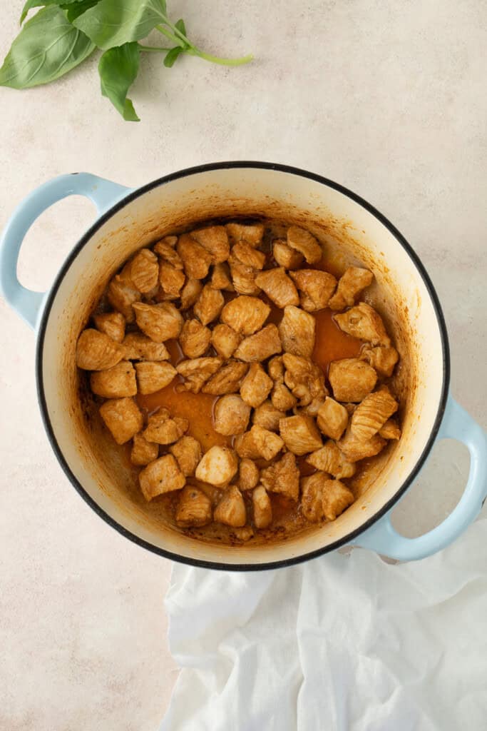 Cooking the chicken in a large pot.