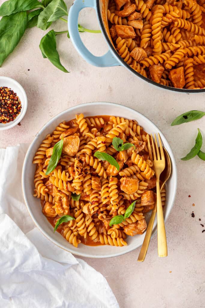 The creamy tomato and chicken pasta served into a bowl.