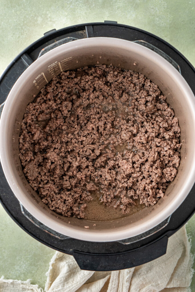 Browning the mince in the slow cooker.