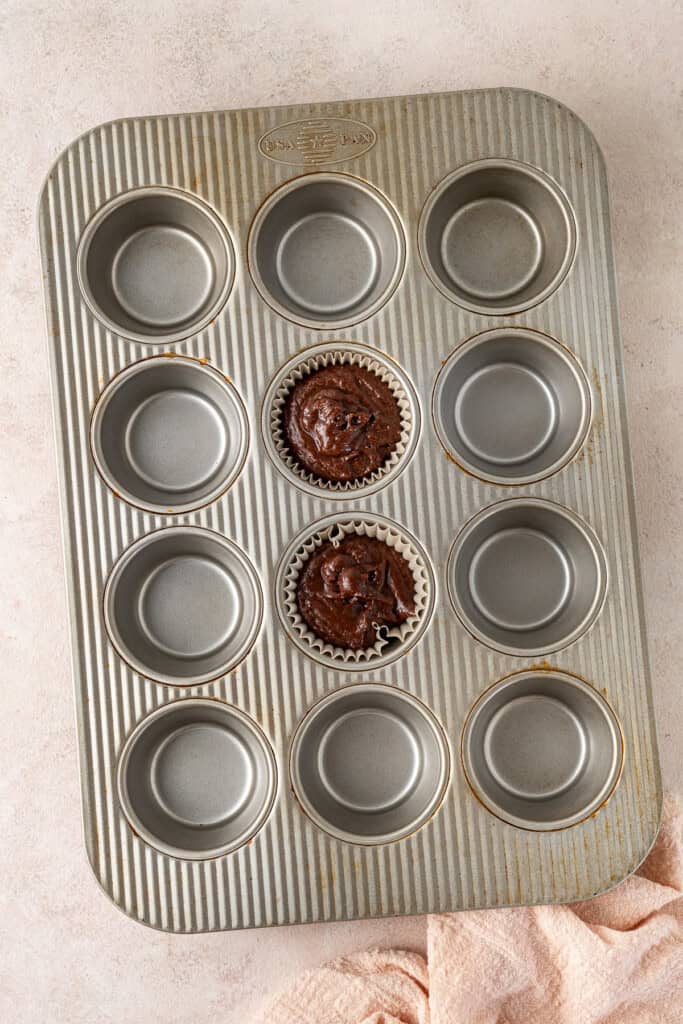 The cupcake batter in a muffin pan.