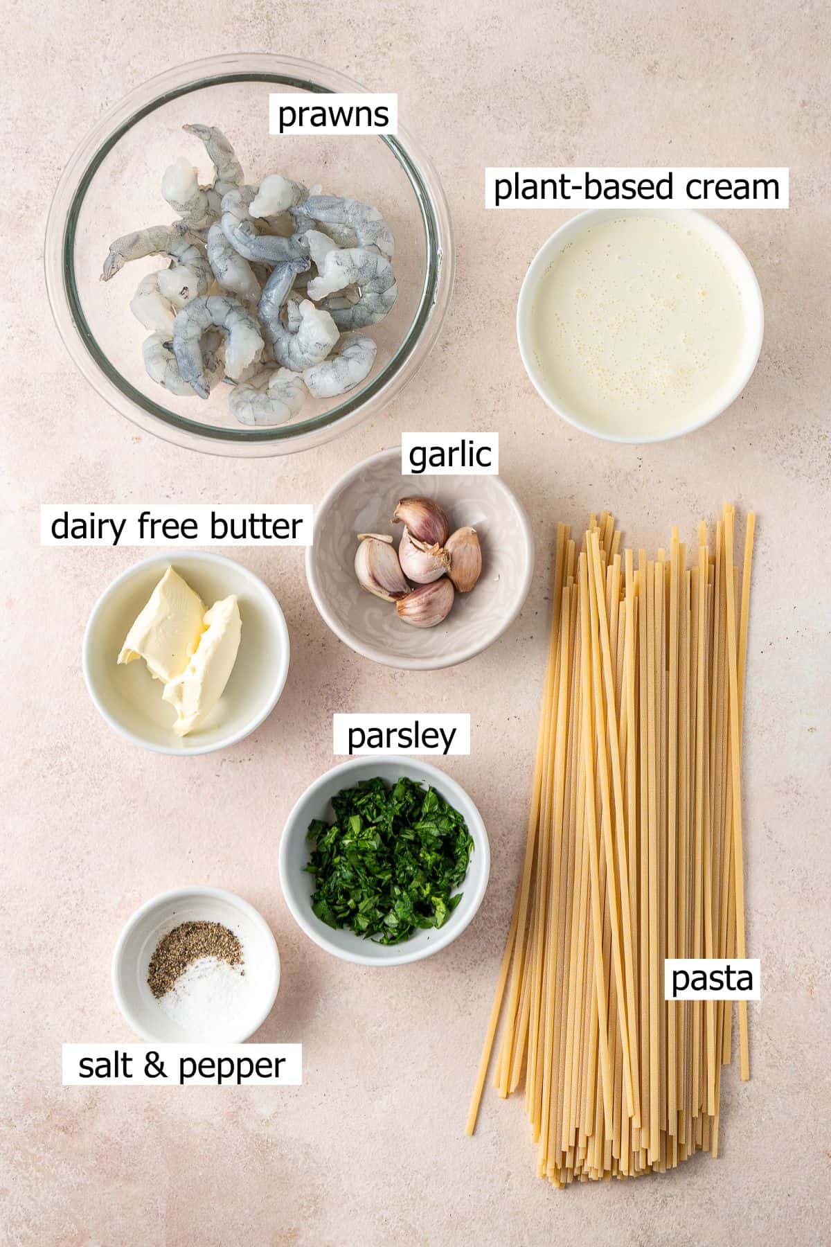 All ingredients for this 15 minute creamy garlic prawn pasta laid out in small bowls.