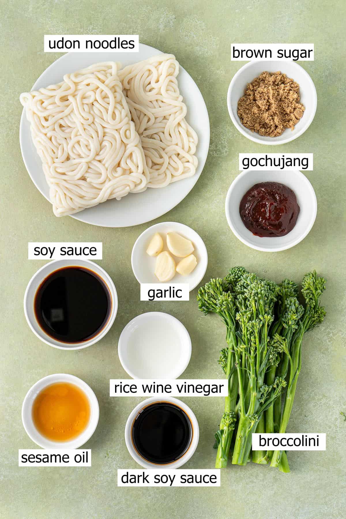 All ingredients needed to make chilli garlic udon noodles laid out in bowls.