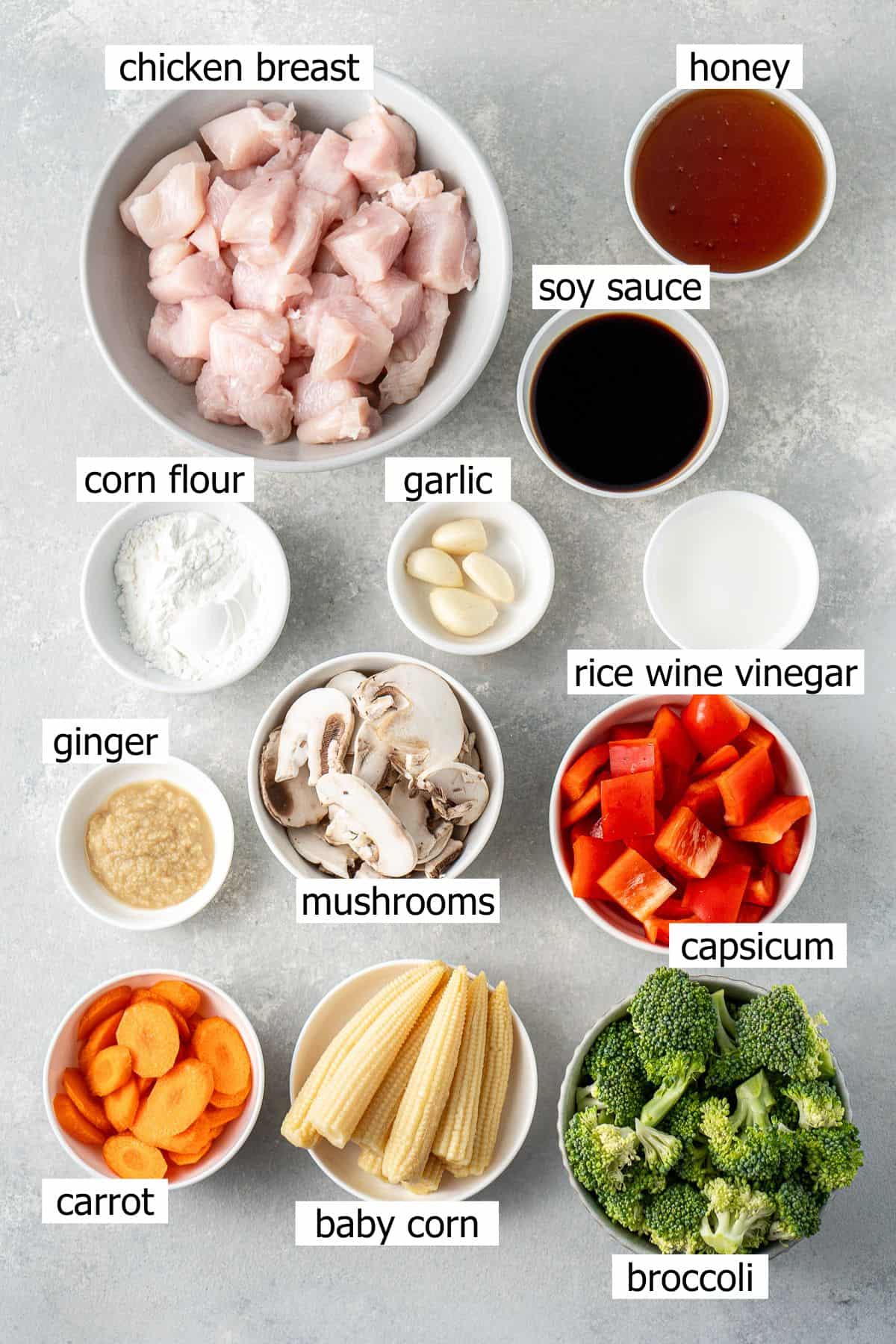 All ingredients needed to make honey garlic stir fry laid out in bowls.