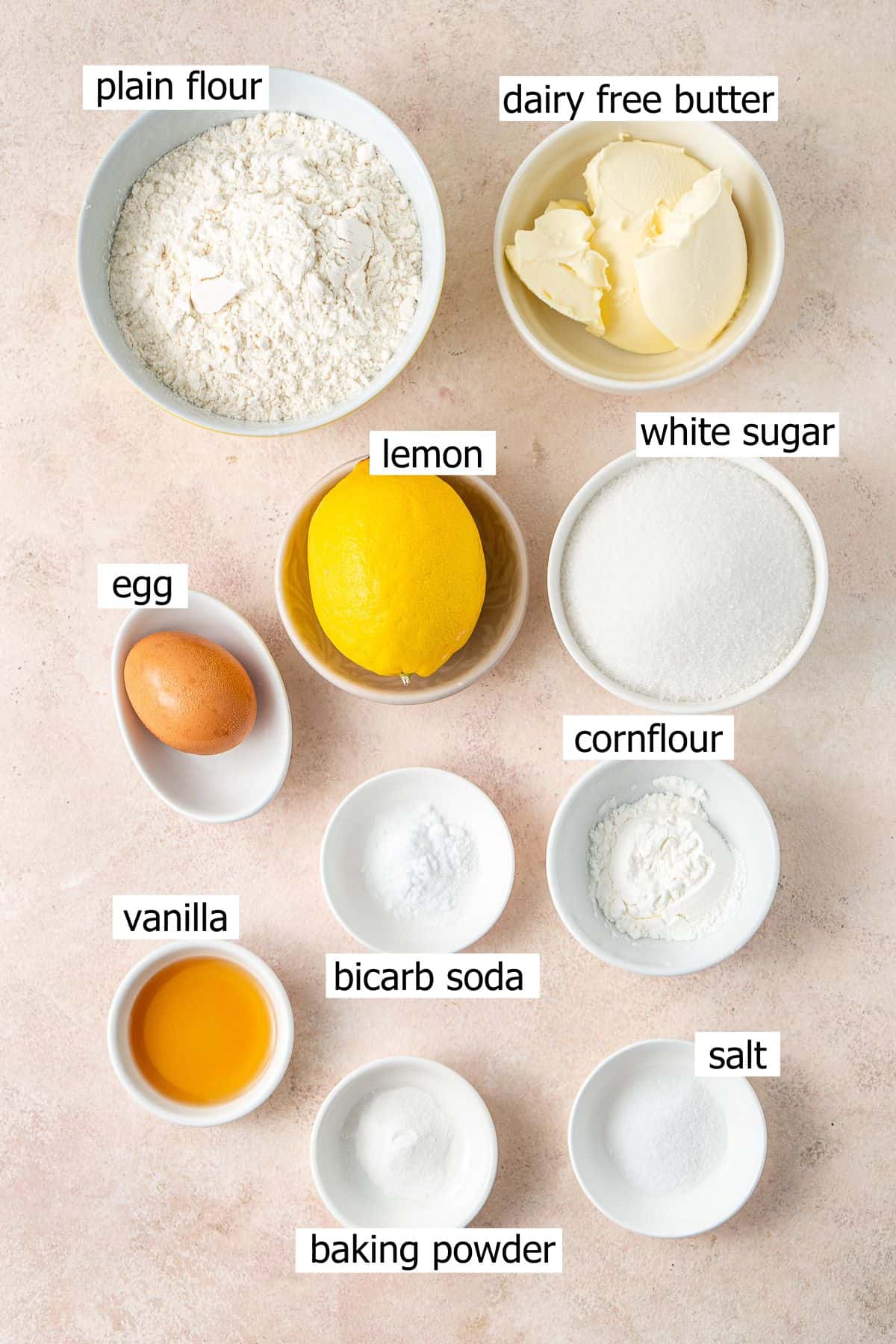 All ingredients needed to make dairy free lemon sugar cookies laid out in small bowls.