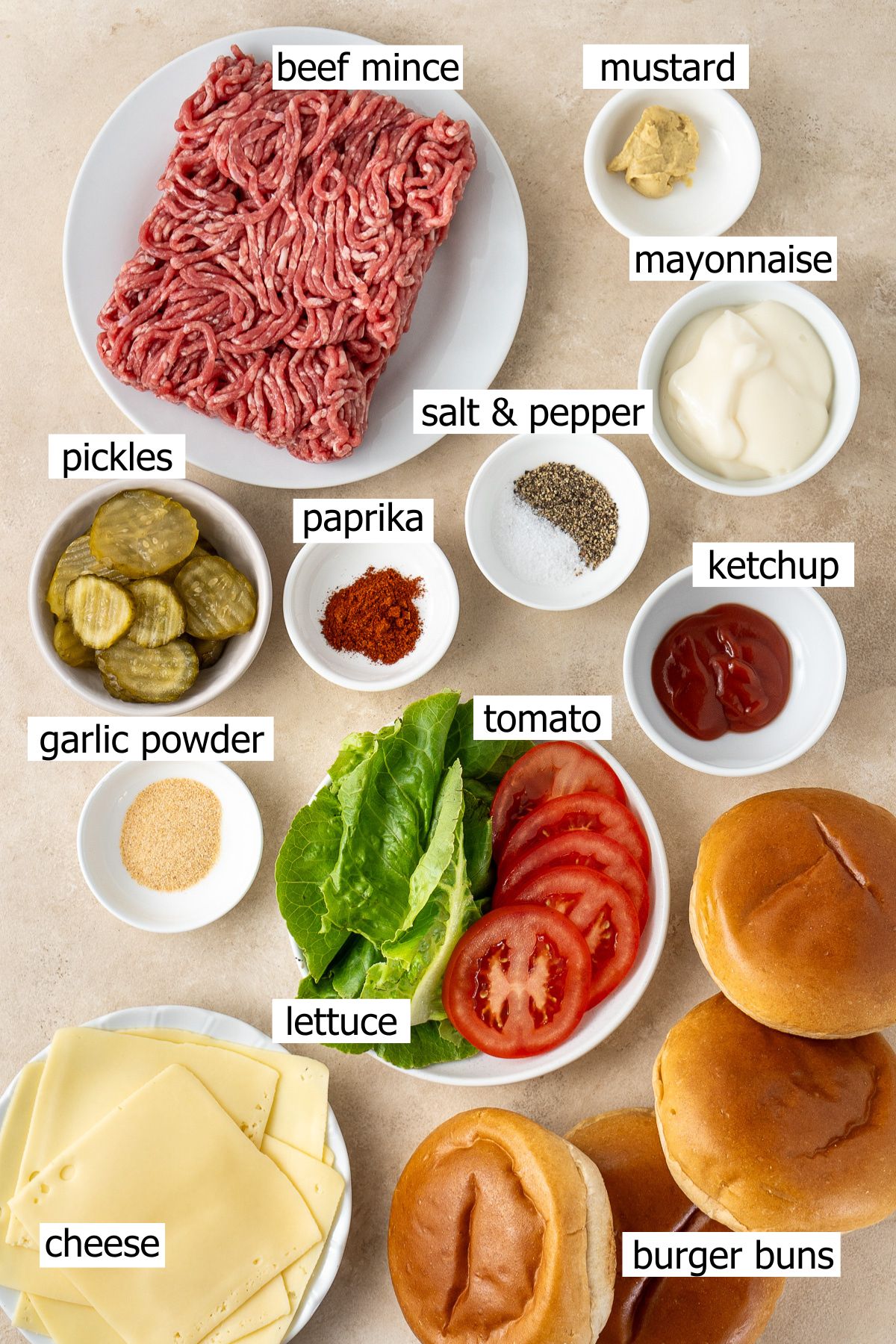 All ingredients needed to make smash burgers and homemade burger sauce laid out in bowls.