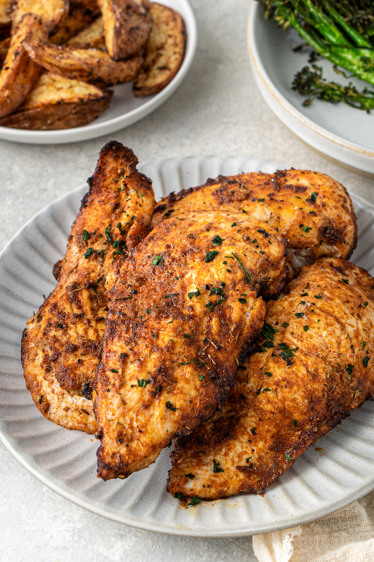 Close up of cooked chicken breast on a plate.