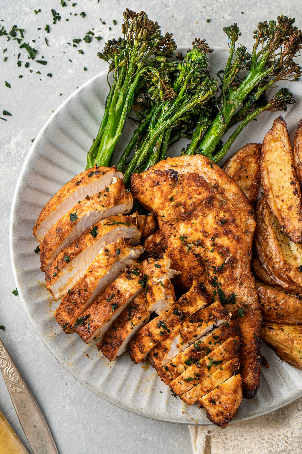 Close up of sliced chicken breast on a plate.