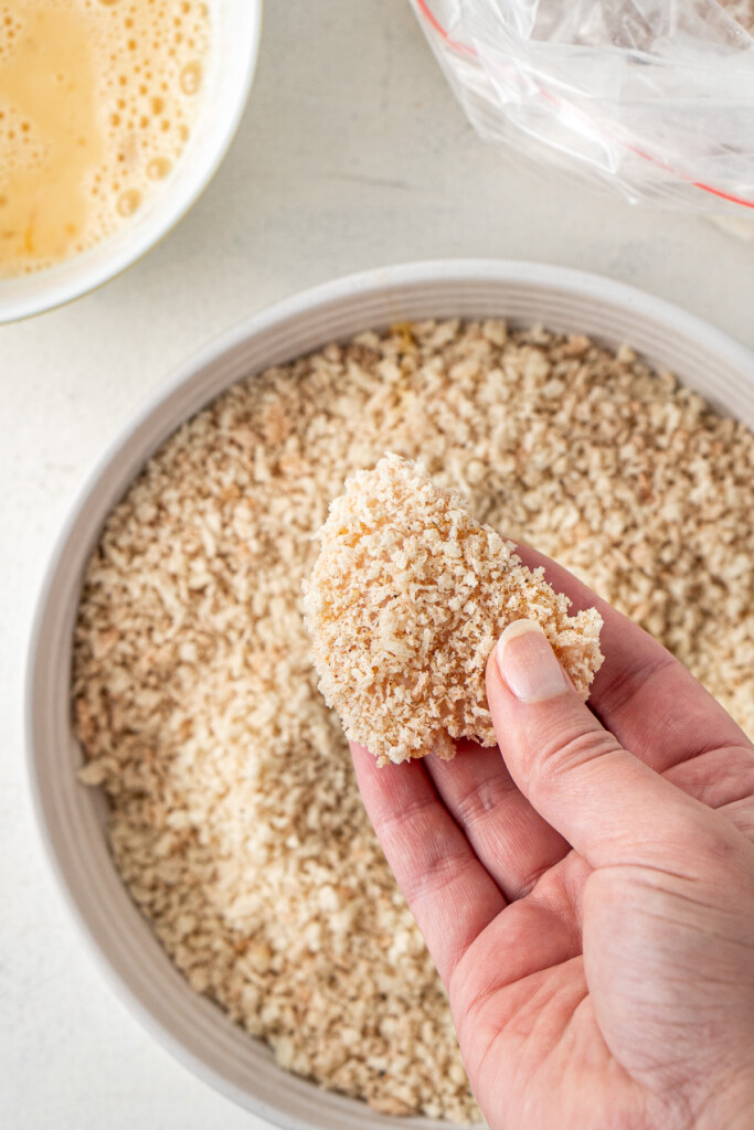 A chicken nugget coated in crumbs.