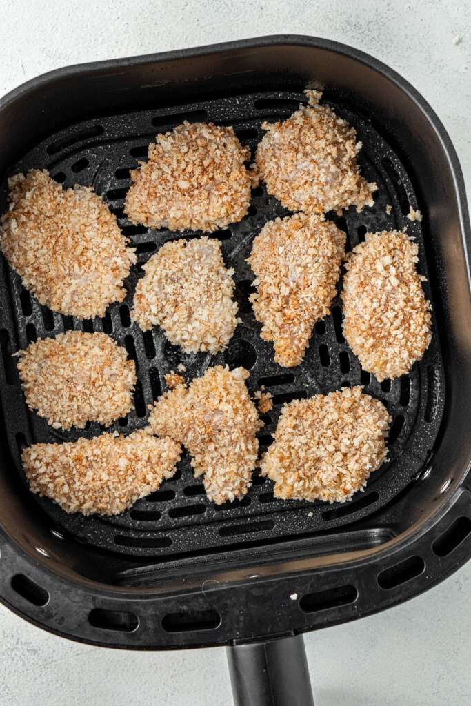 Chicken nuggets in the basket of the air fryer.