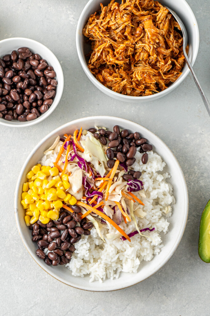 Assembling the BBQ chicken bowl.