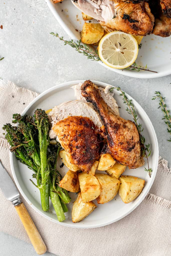 A roast chicken dinner served with air fryer broccolini.