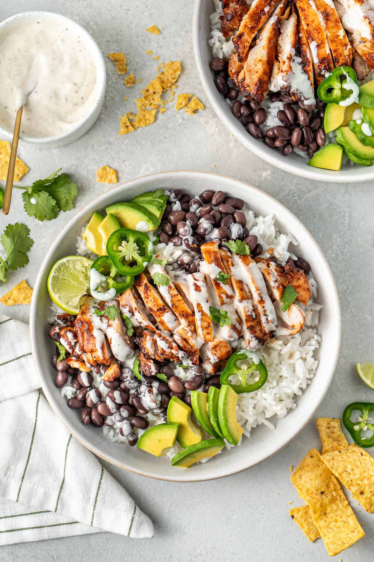 Chipotle chicken bowls with black beans, rice, avocado and mayo.