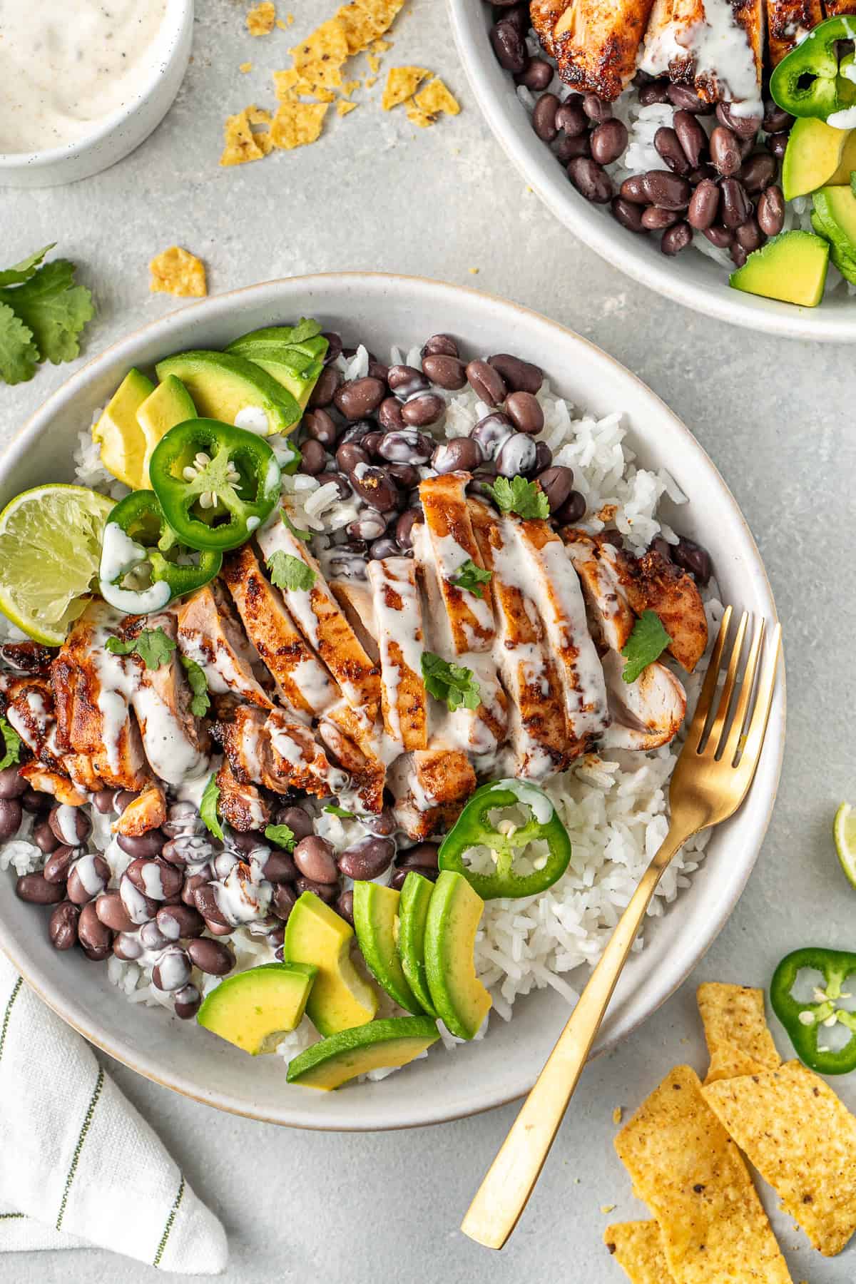 Chipotle chicken bowls with jalapenos and corn chips. 