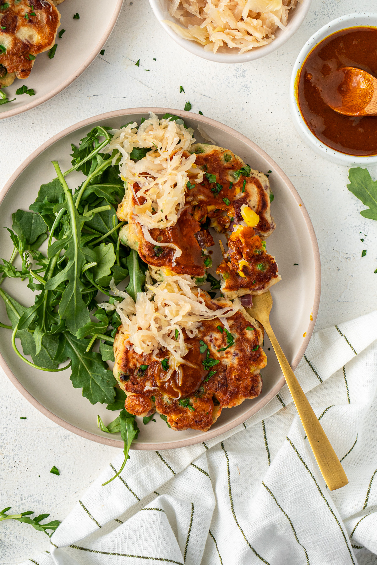 Fritters served with salad and sauerkraut. 